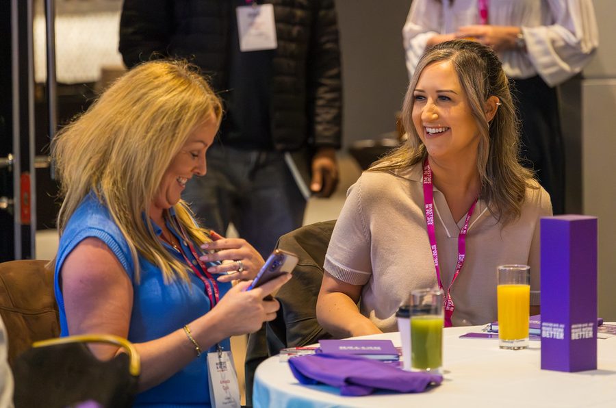 Two delegates sharing notes at an Investors in People event
