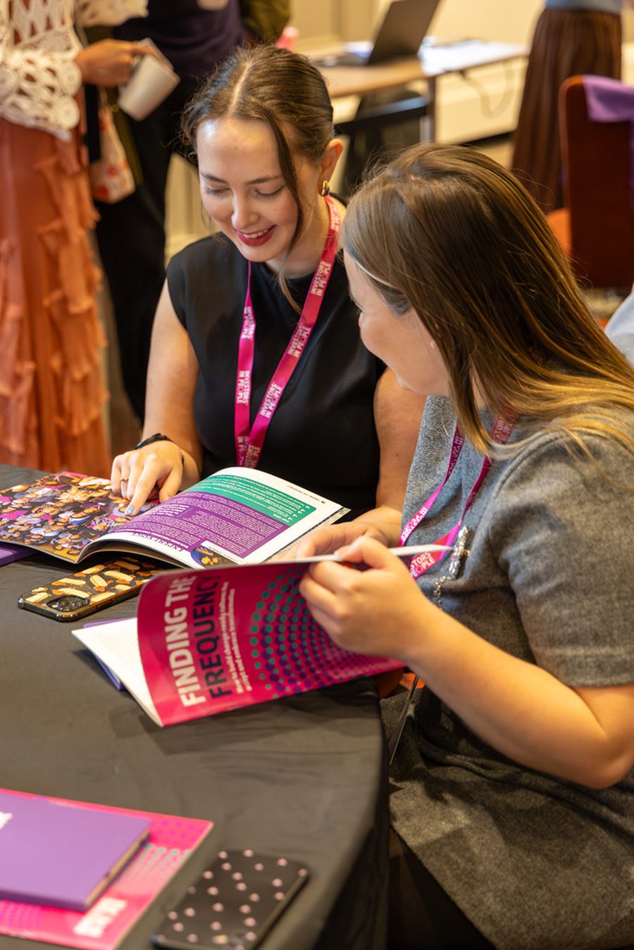 Two delegates in conversation at an Investors in Young People event