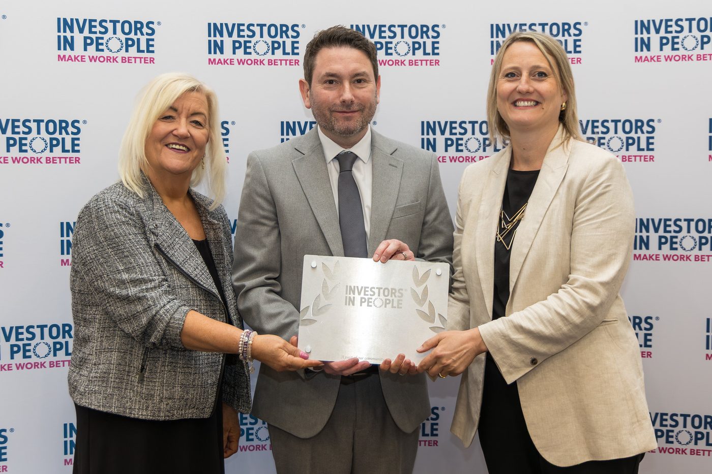 An organisation collecting its Investors in People award