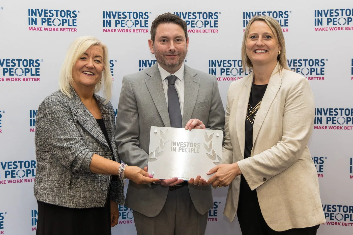 An organisation collecting its Investors in People award