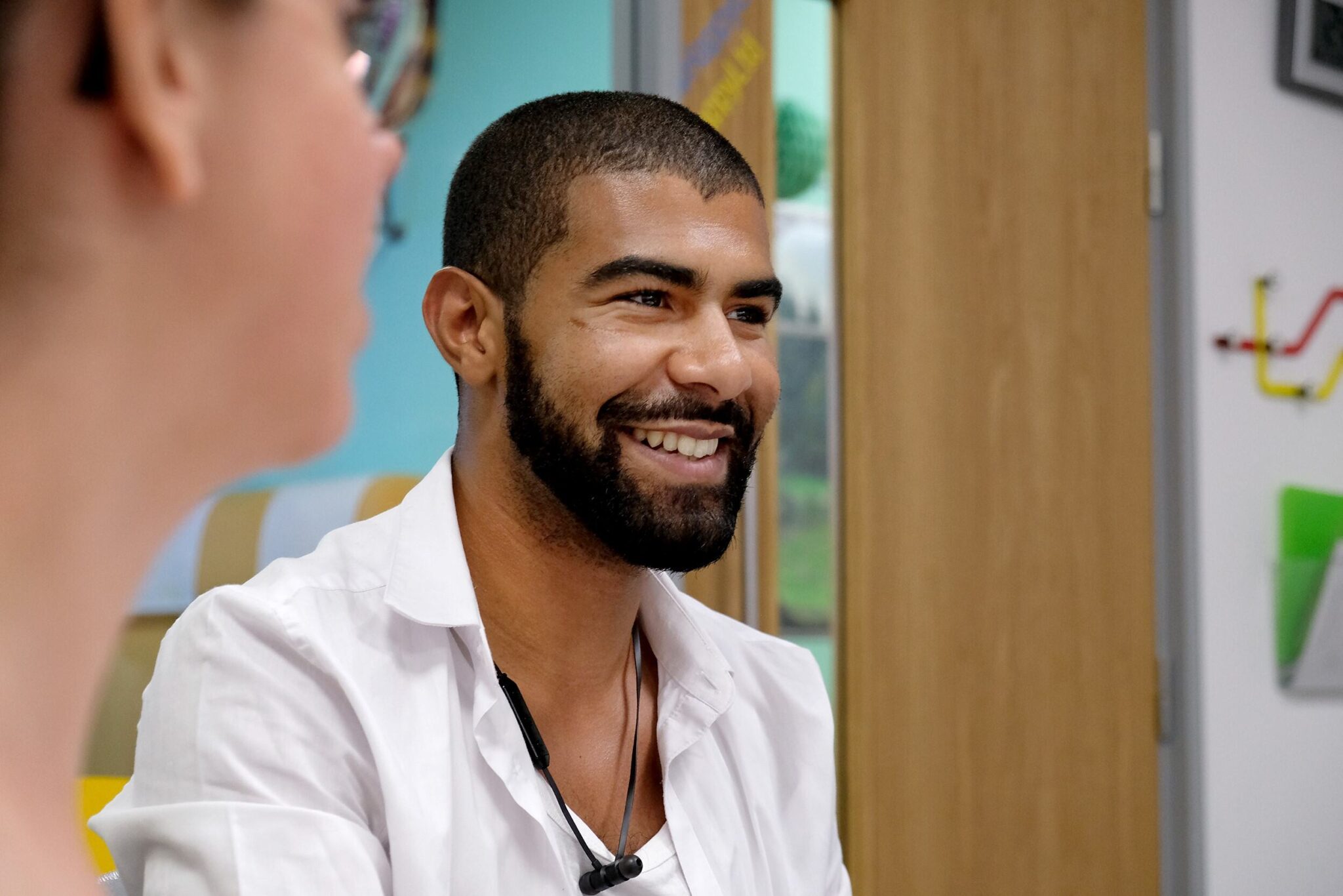 A Happy team member smiling during a conversation