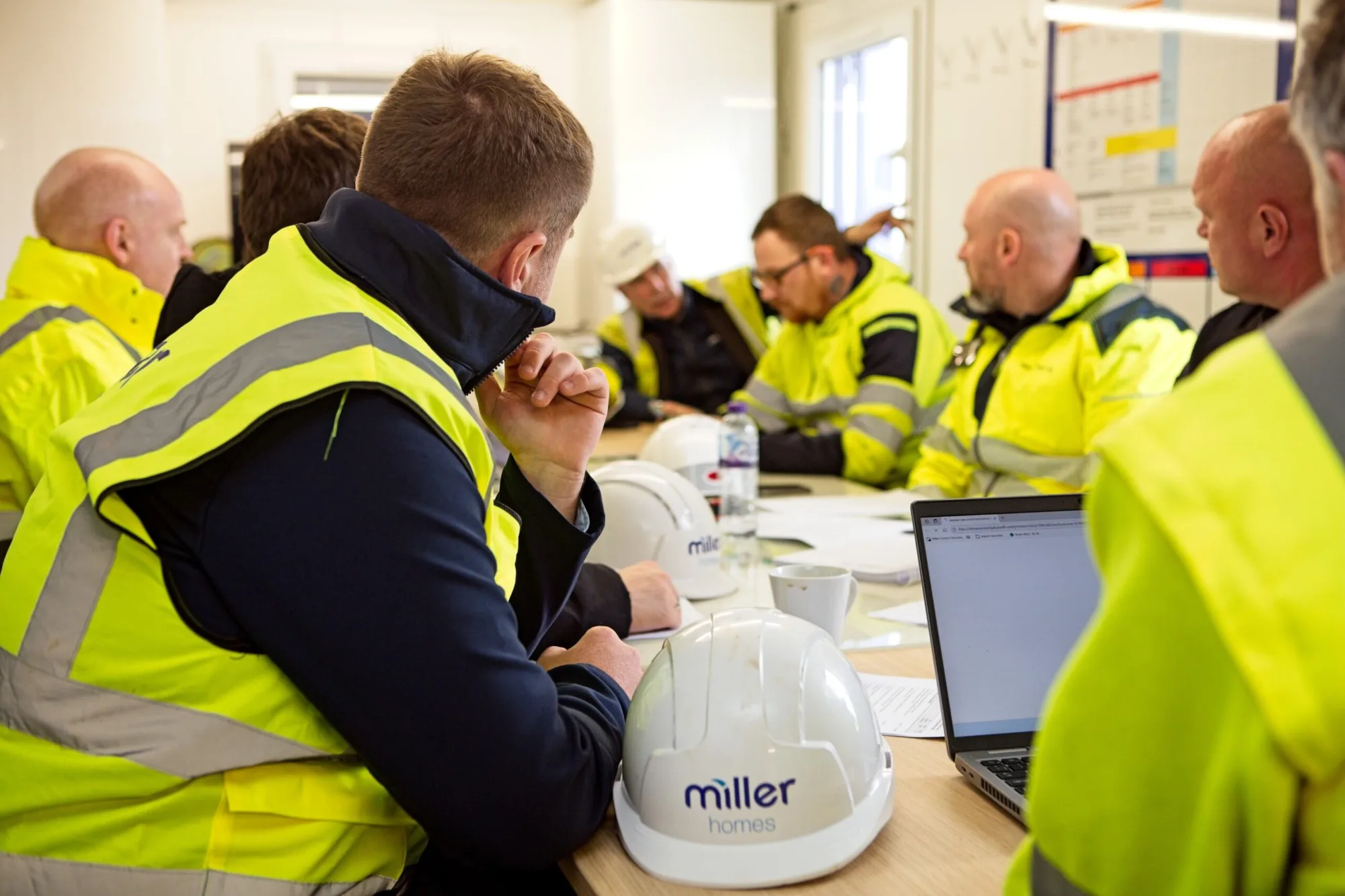 Miller Homes site team in a meeting on site