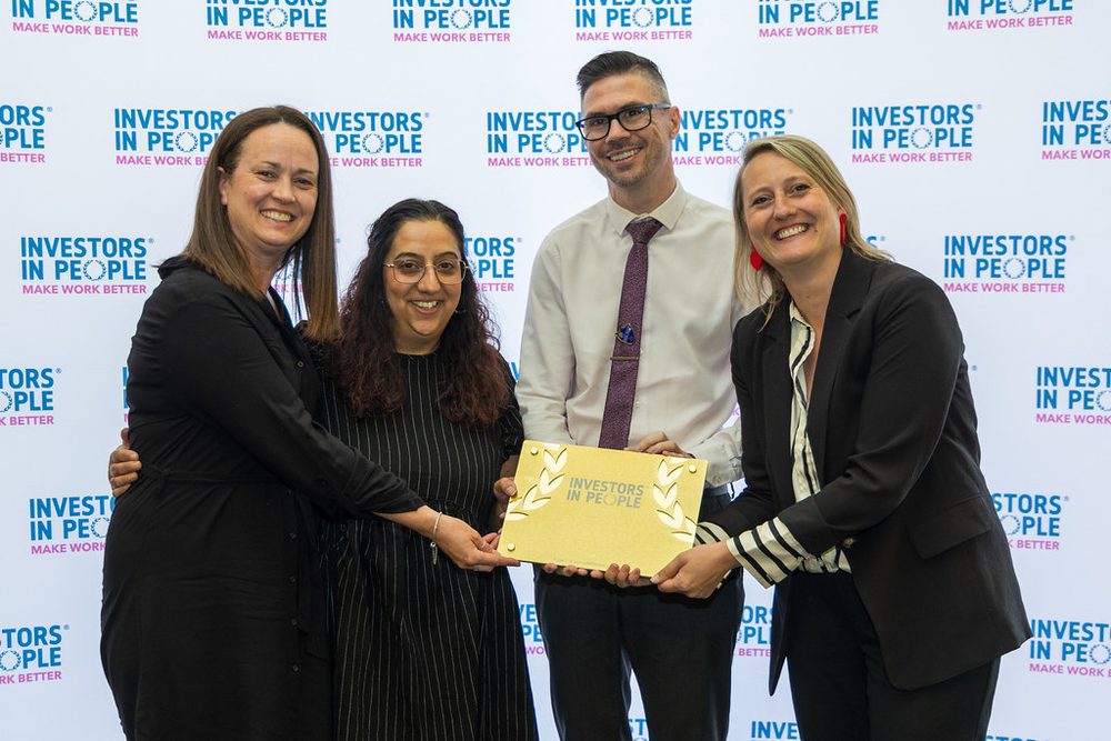 An accredited organisation collecting their Investors in People plaque